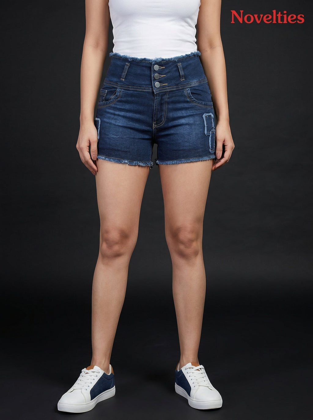 Model wearing Novelties® high-waisted dark wash denim shorts with a multi-button closure and frayed hem.