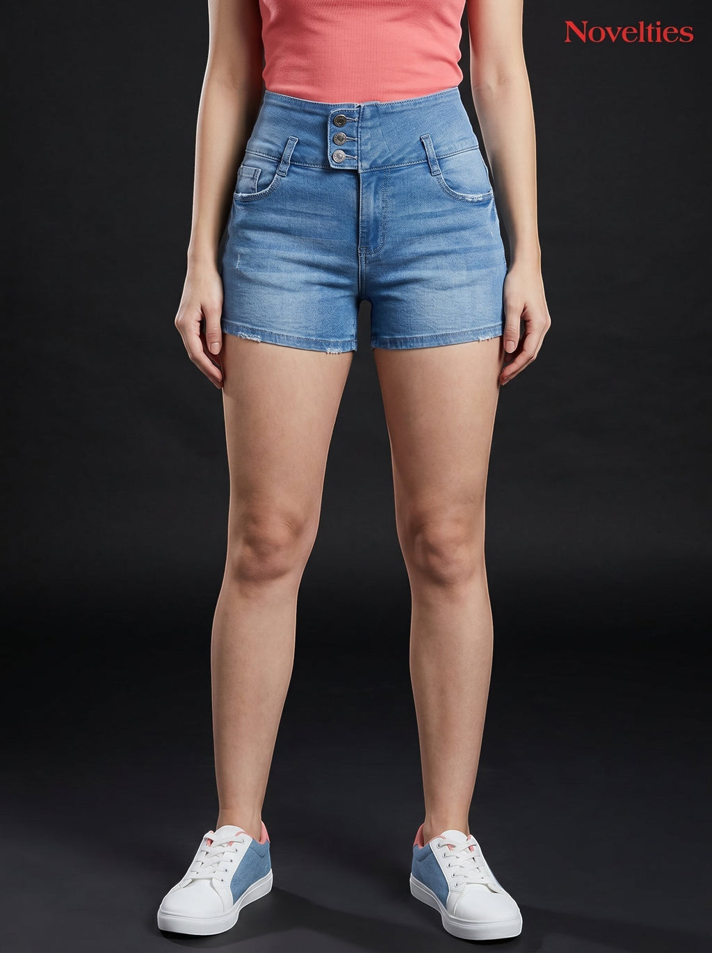 Model wearing Novelties® light blue high-waist denim hot shorts with triple-button closure and raw fray hem.