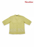 Novelties® lime green mandarin collar shirt featuring white cutwork floral embroidery at the hem and button-down front.