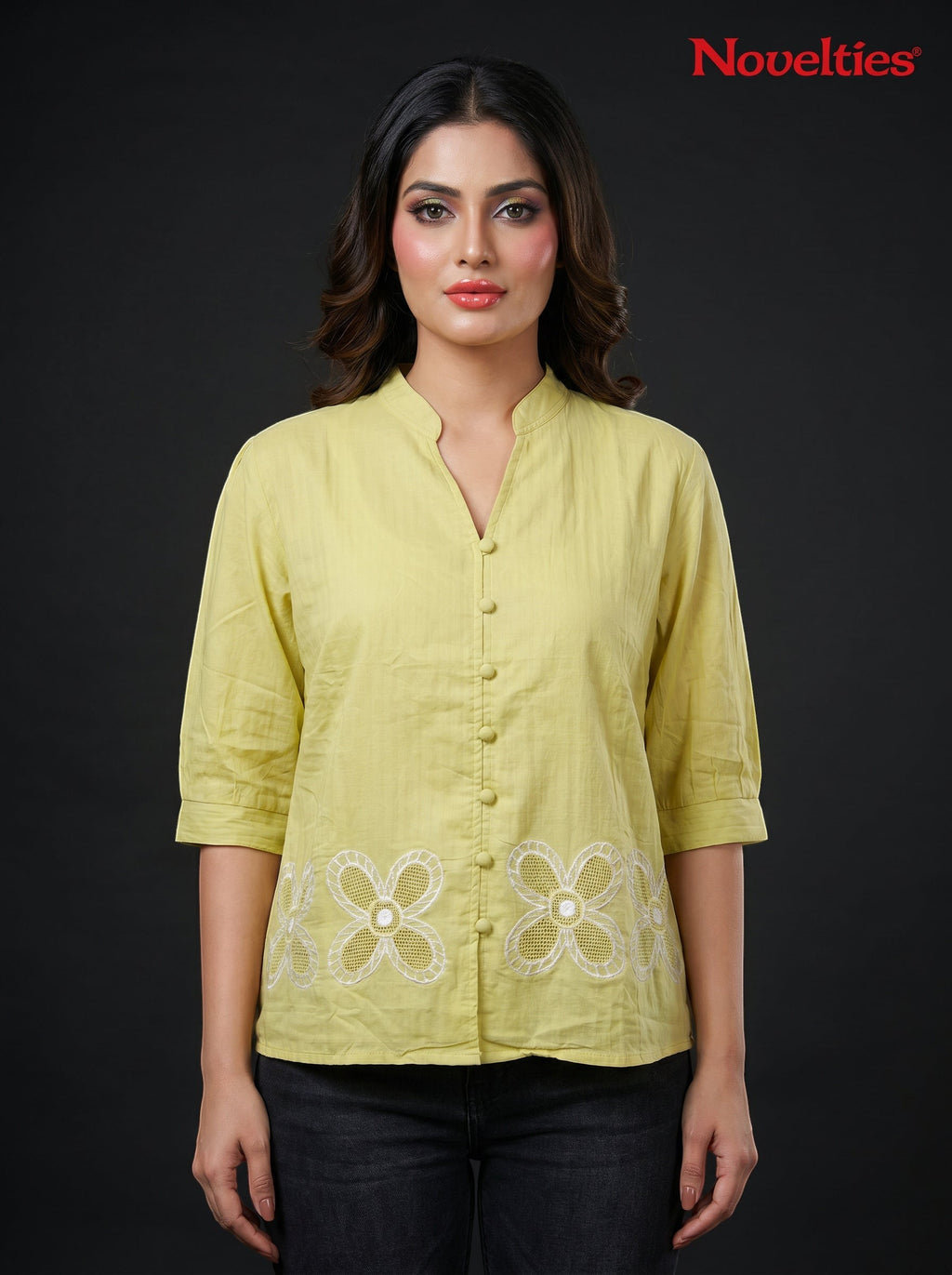 Model wearing a lime green Novelties® mandarin collar shirt with white cutwork floral embroidery at the hem.