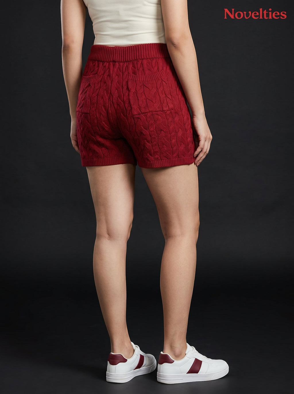 Model wearing Novelties® maroon cable-knit shorts with an elasticated waistband and ribbed hem against black background