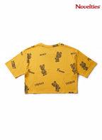 Novelties® mustard yellow crop top with all-over teddy bear graphic print and France typography.