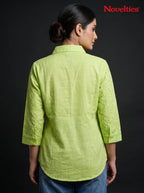 Model wearing a lime green Novelties® Schiffli embroidered shirt with three-quarter sleeves against a black background.