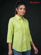 Model wearing a lime green Novelties® Schiffli embroidered button-down shirt with three-quarter sleeves.