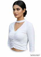 Model wearing a white Novelties® long sleeve cropped top with a choker neck, V-cutout, and centre-front ruching.
