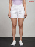 Model wearing Novelties® high-rise white denim shorts with a cuffed hem, paired with a lavender top and white sneakers.