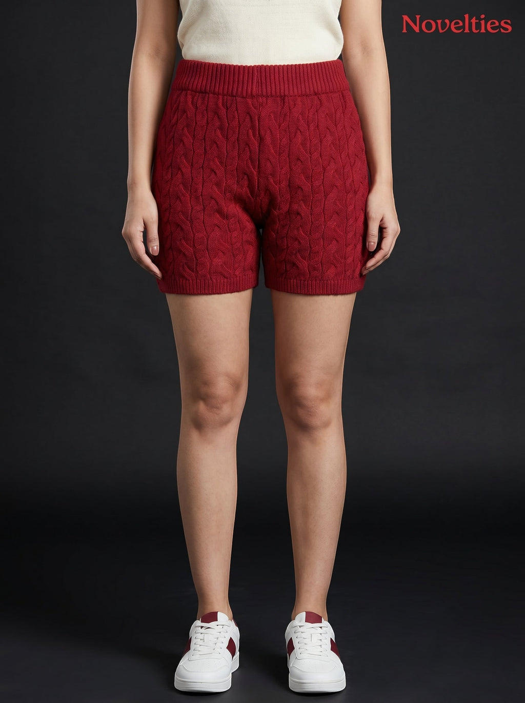 Model wearing Novelties® maroon cable-knit shorts with an elasticated waistband and ribbed hem against black background