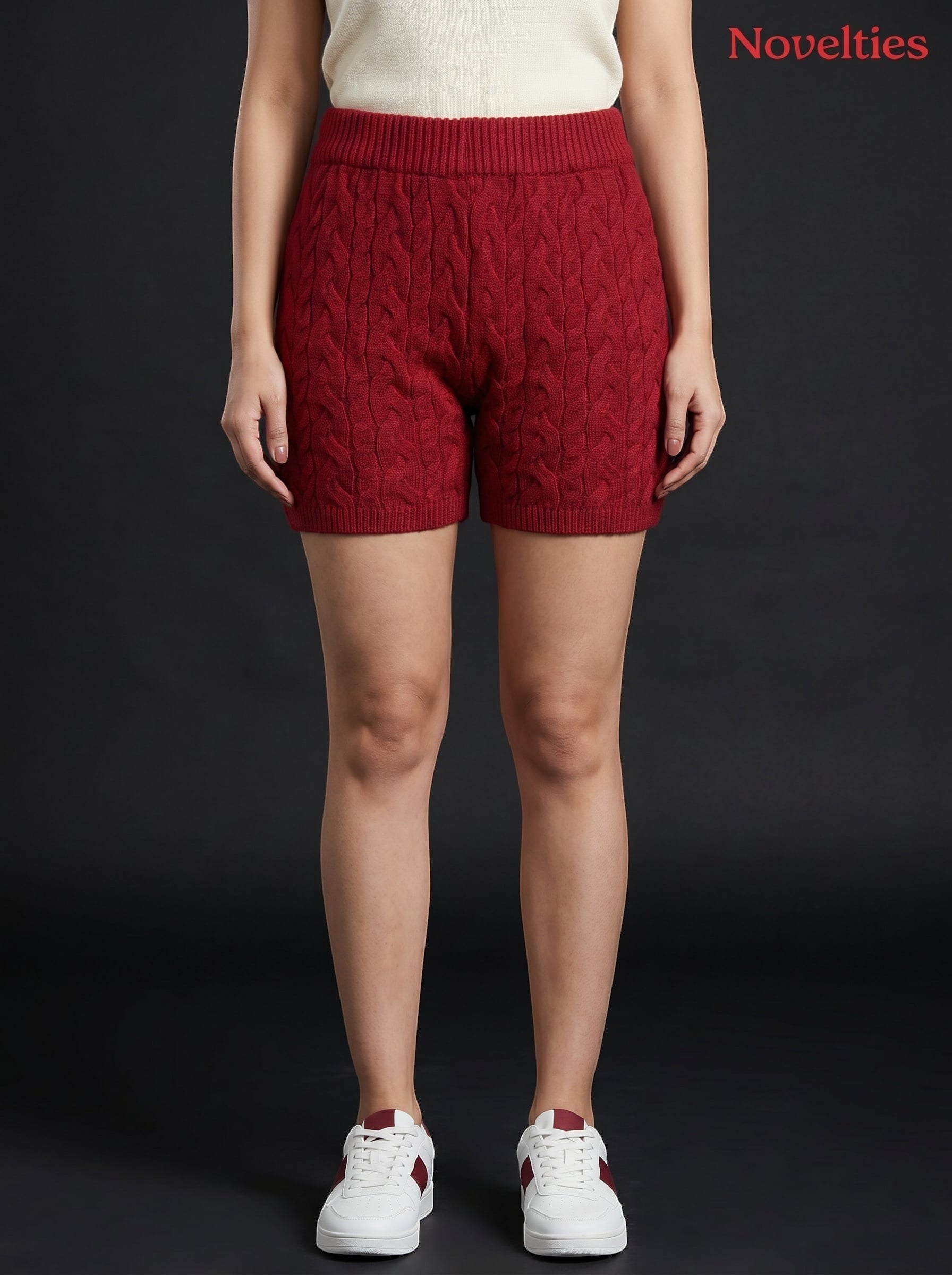 Model wearing Novelties® maroon cable-knit shorts with an elasticated waistband and ribbed hem against black background