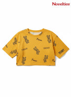 Novelties® mustard yellow crop top with all-over teddy bear graphic print and France typography.